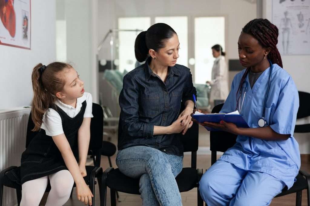 family-discussing-medical-treatment-with-african-american-nurse-in-hospital-1024×682